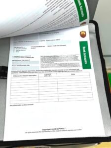 "This image shows a printed 'Getting Started' document from RIPVault, a personal life organizer. The document outlines the process of organizing personal life details, such as important documents and emergency information. The RIPVault logo is visible at the top, and the document is placed on a desk with various other items in the background."
